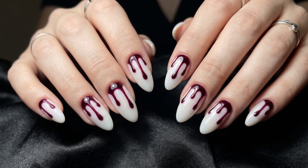 Deep merlot wine blood drip nail art over milky white base on short natural nails for Halloween